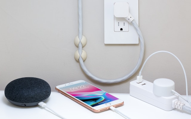 Multiple smart devices charging through power outlets.