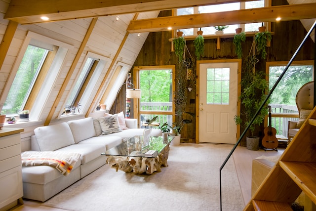 A photo of a living room with high wooden beams
