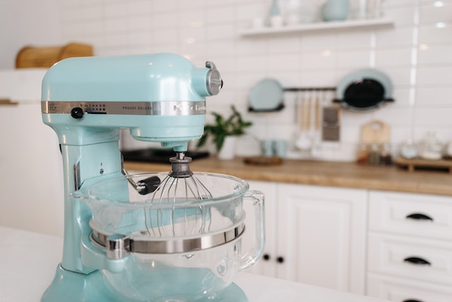 A stand mixer on the table.